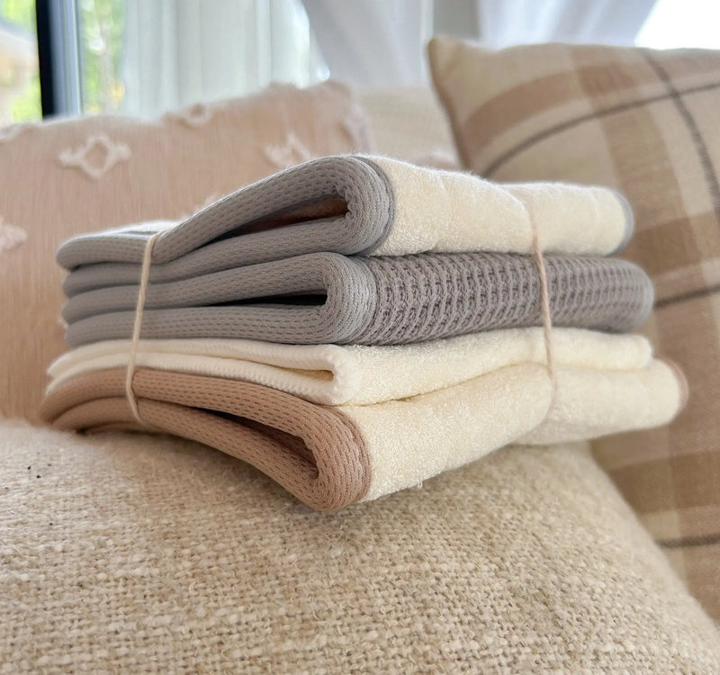 The Insert Sampler pack with layered waffle, flex fit, slim fit, and bamboo terry inserts stacked on a sofa.