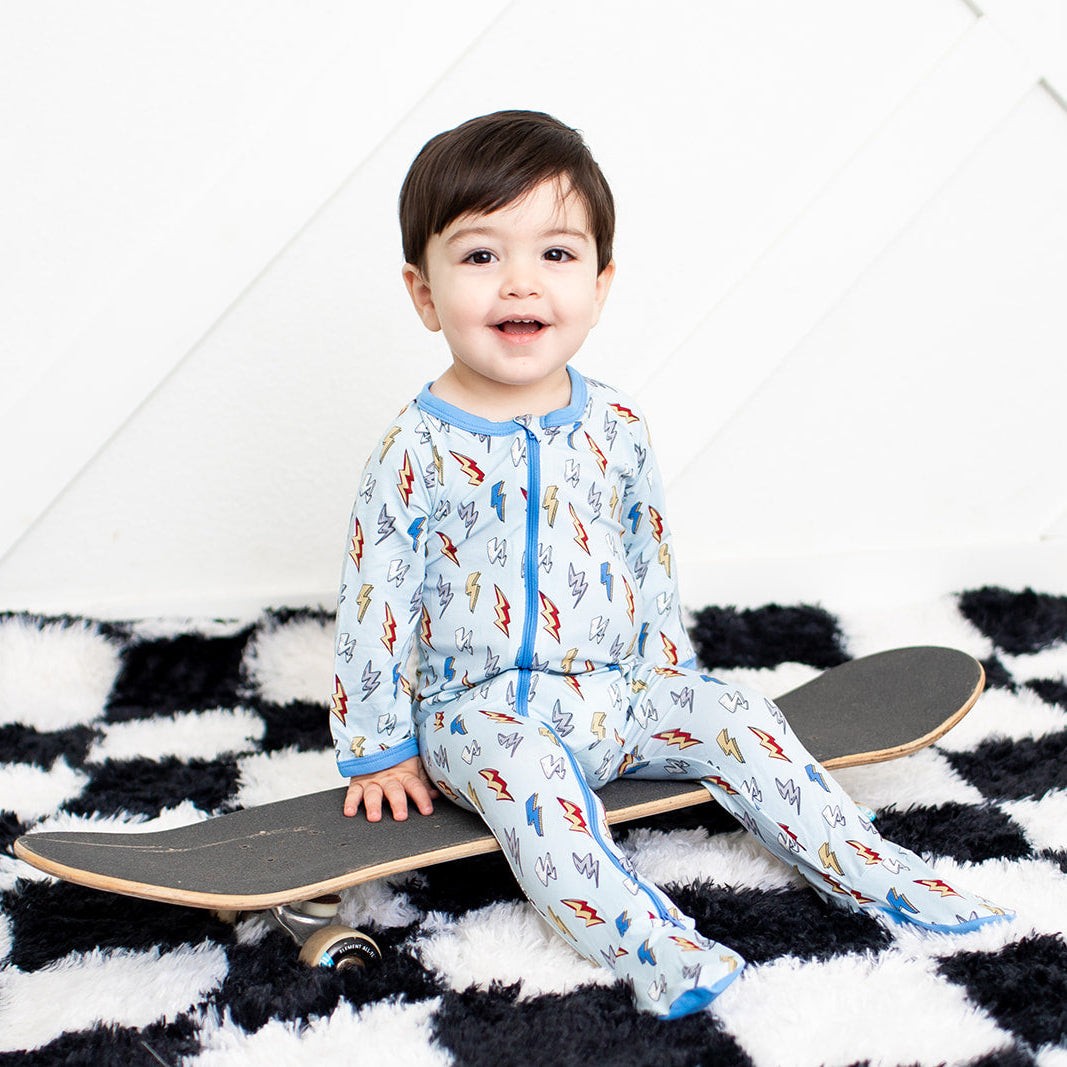 Baby footie pajamas with thunderbolt print and two-way front zipper, covered feet
