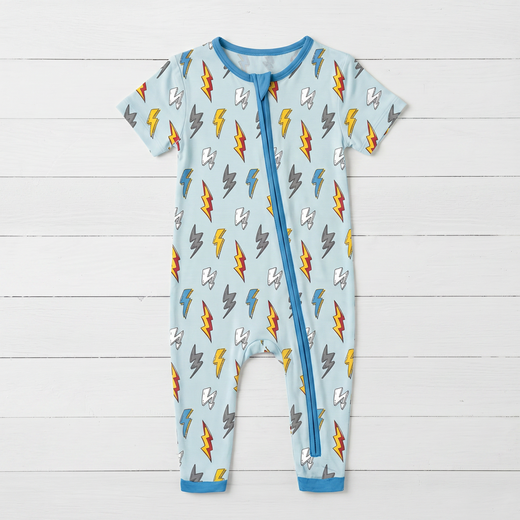Baby romper with long sleeves and legs in a thunderbolt print, with a two-way front zipper
