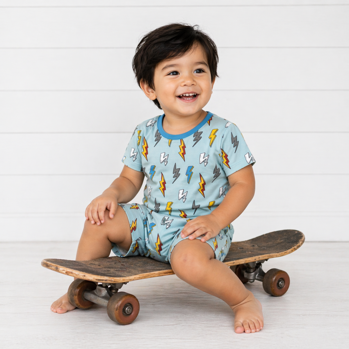 Two-piece baby pajama set with short sleeve thunderbolt print top and matching shorts