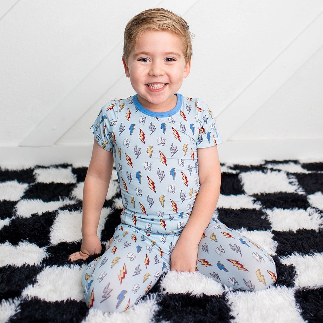Two-piece pajama set with short sleeve top and long pants in a thunderbolt lightning bolt print