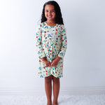 Long-sleeve toddler dress with a full twirl skirt, shown on a smiling child