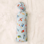 Swaddle blanket with a tiny travelers print, shown spread flat as a large square wrap