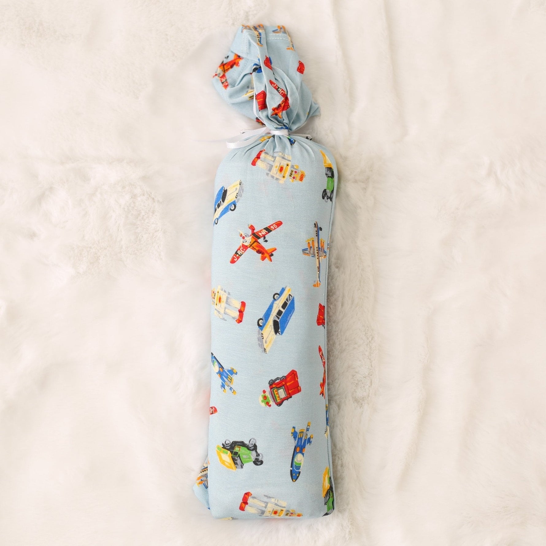 Swaddle blanket with a tiny travelers print, shown spread flat as a large square wrap