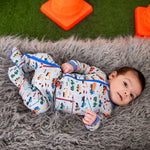 Baby footie pajamas with an all-over construction truck print and a two-way front zipper.