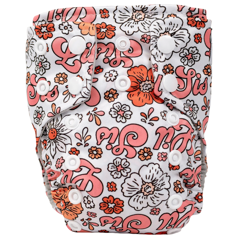 Tiny Tushies Newborn AIO Cloth Diaper with floral print and snap closures.