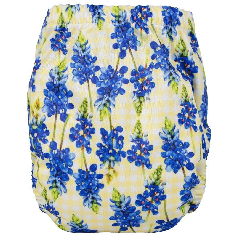 Tiny Tushies Newborn AIO Cloth Diaper with blue floral pattern on yellow background.