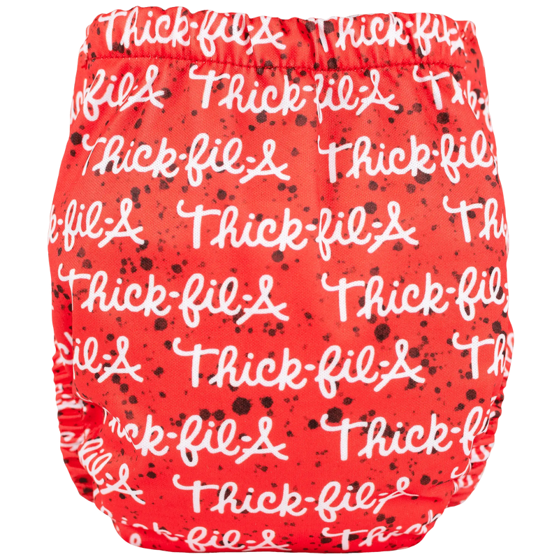 Tiny Tushies Newborn AIO Cloth Diaper with red printed design, featuring adjustable snaps and pocket opening.