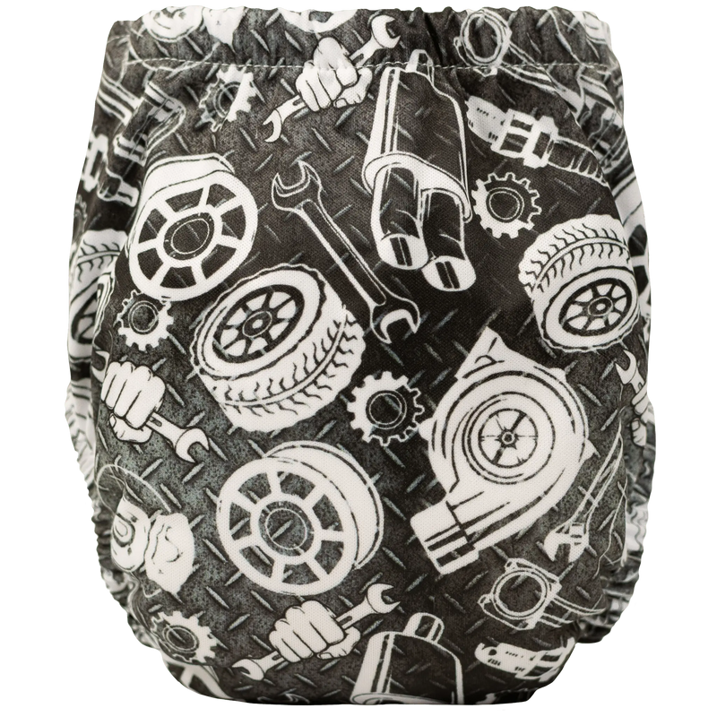 Tiny Tushies Newborn AIO cloth diaper with tool pattern, showing front view.
