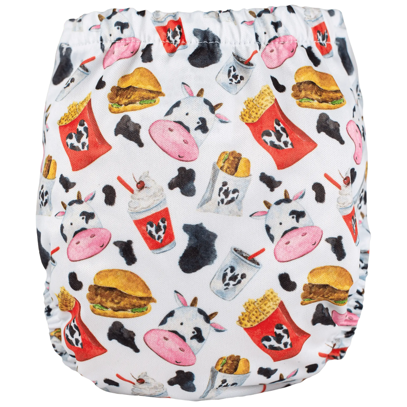 Tiny Tushies Newborn AIO Cloth Diaper with colorful food and cow print design.