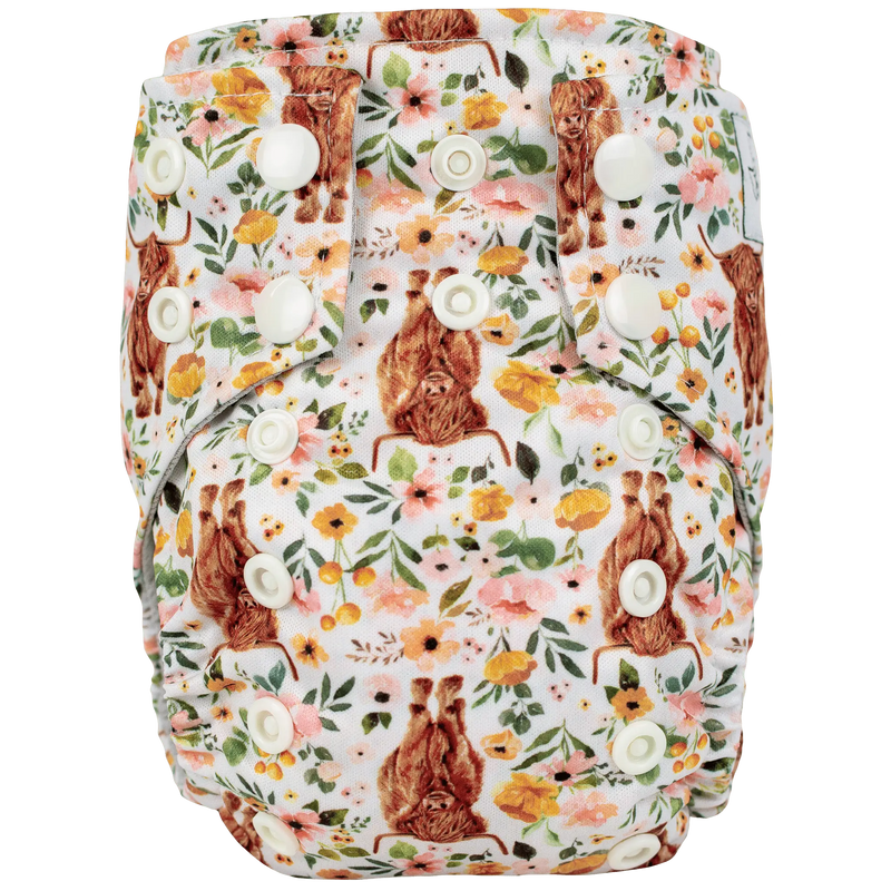 Tiny Tushies Newborn AIO Cloth Diaper with floral print and adjustable snaps.