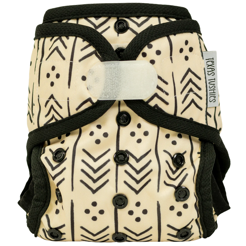 Tiny Tushies Newborn Cover with hook & loop fastener, adjustable fits 5-20 lbs, featuring umbilical cord snap and tummy panels.