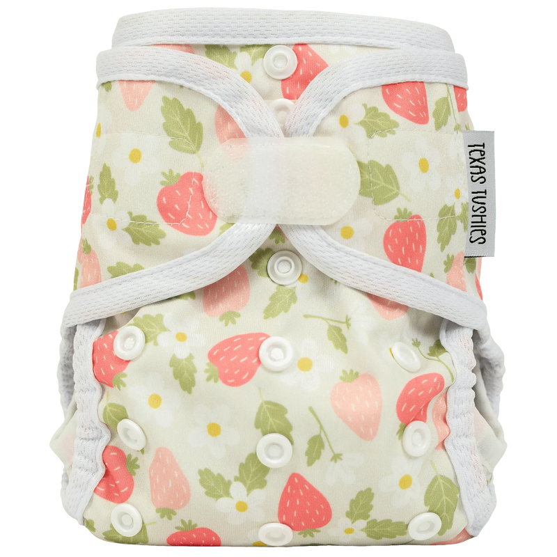 Tiny Tushies Newborn Cover with hook and loop closure and floral print design.