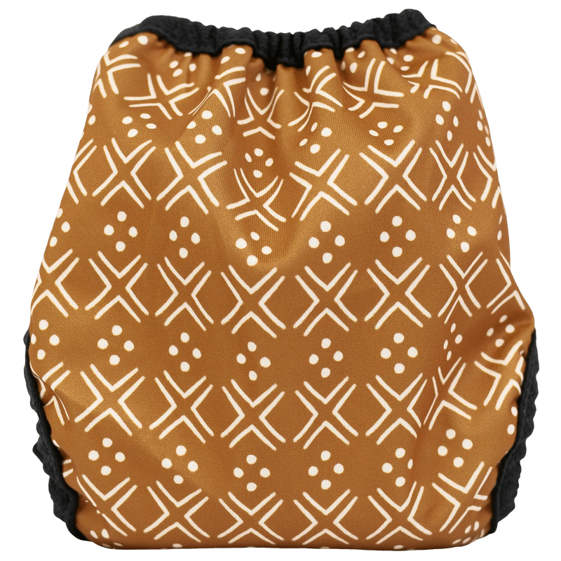 Tiny Tushies Newborn Hook & Loop Cover with geometric pattern, adjustable fit, and soft PUL fabric.