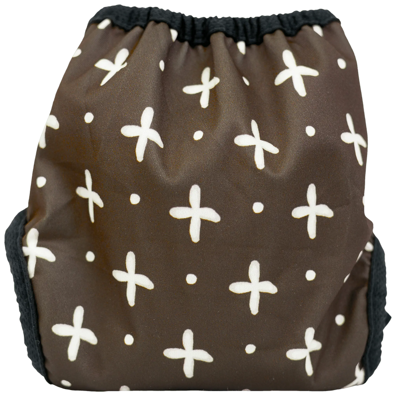 Tiny Tushies Newborn Cover with brown and white cross pattern.