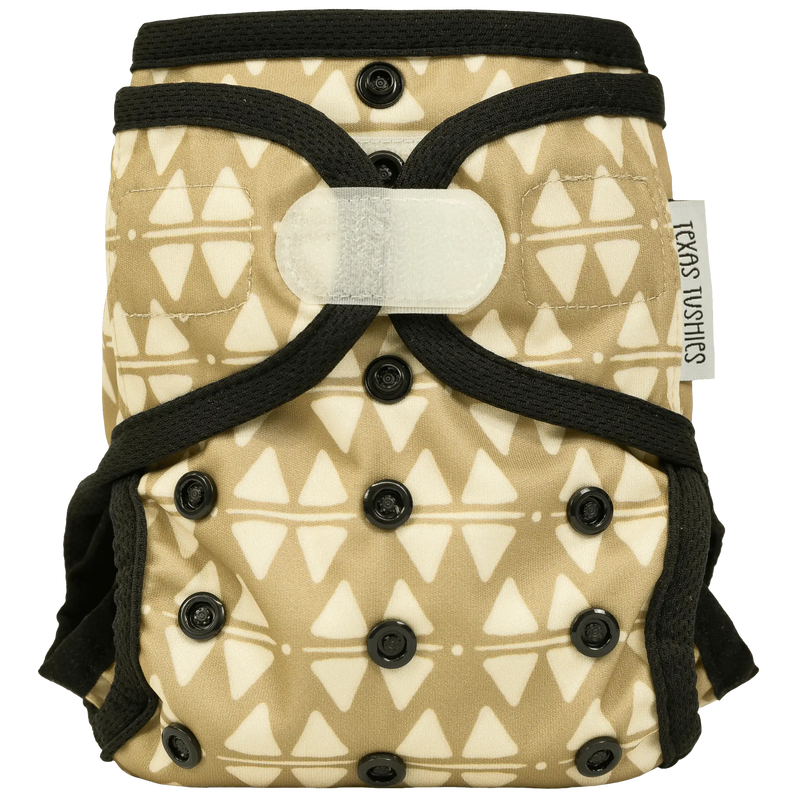 Tiny Tushies Newborn Hook & Loop Cover with adjustable settings and umbilical cord snap down, designed for infants 5-20 lbs.