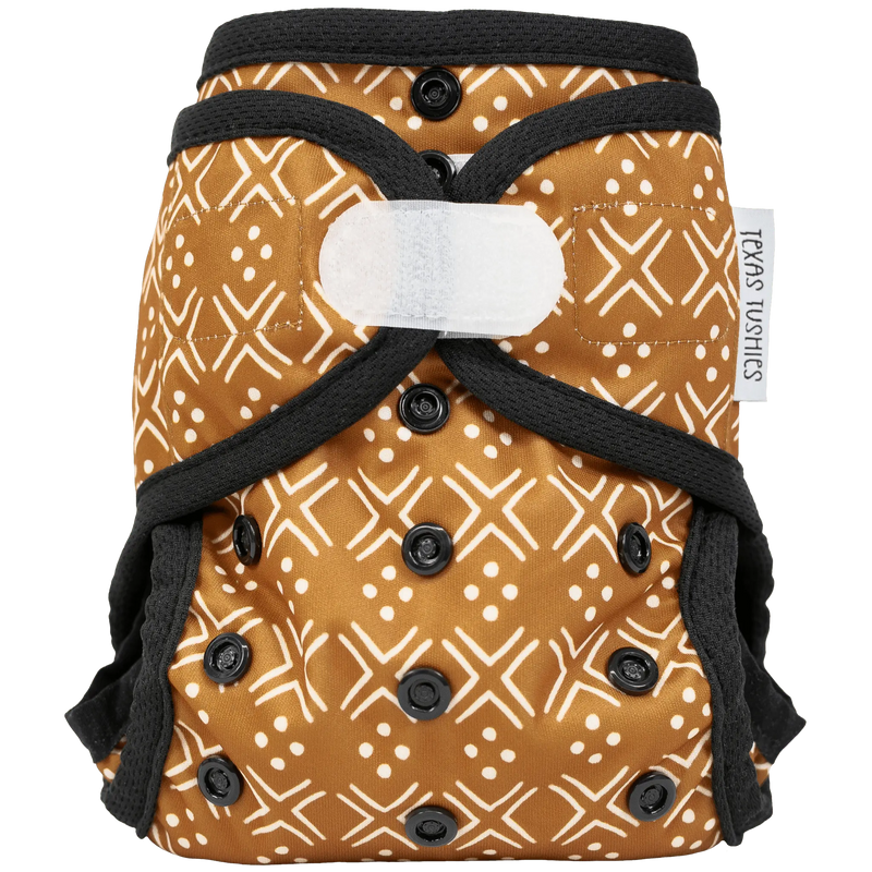 Tiny Tushies Newborn Hook & Loop Cover with adjustable fit and umbilical cord snap down.