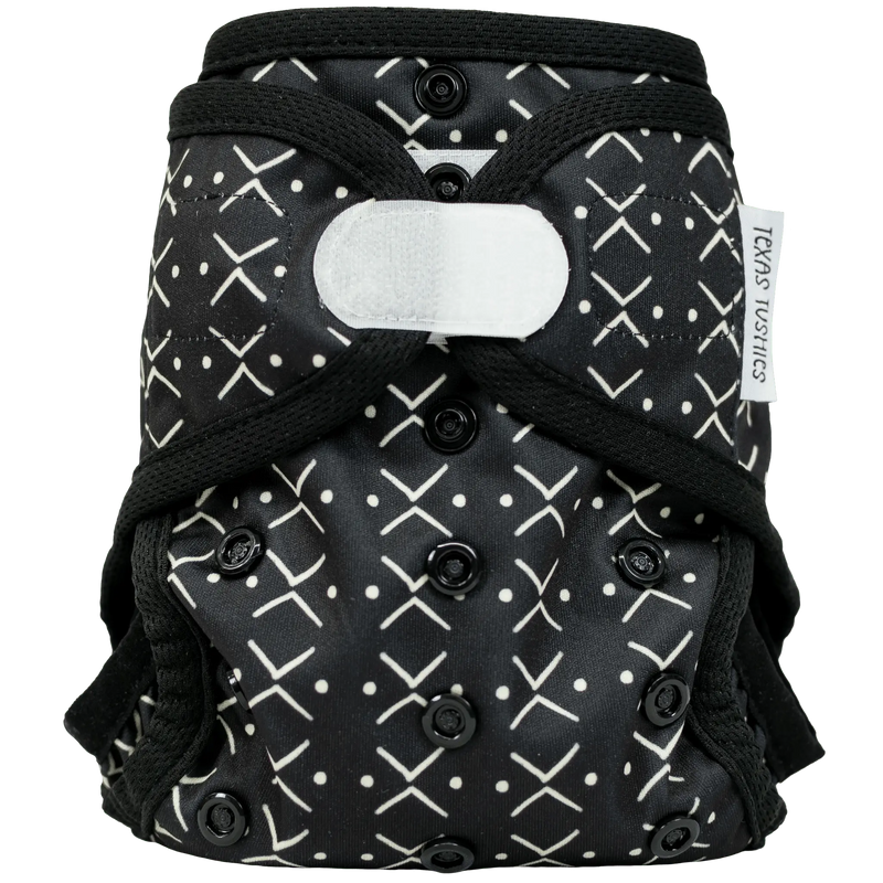 Tiny Tushies Newborn Hook & Loop Cloth Diaper Cover with adjustable rise settings.