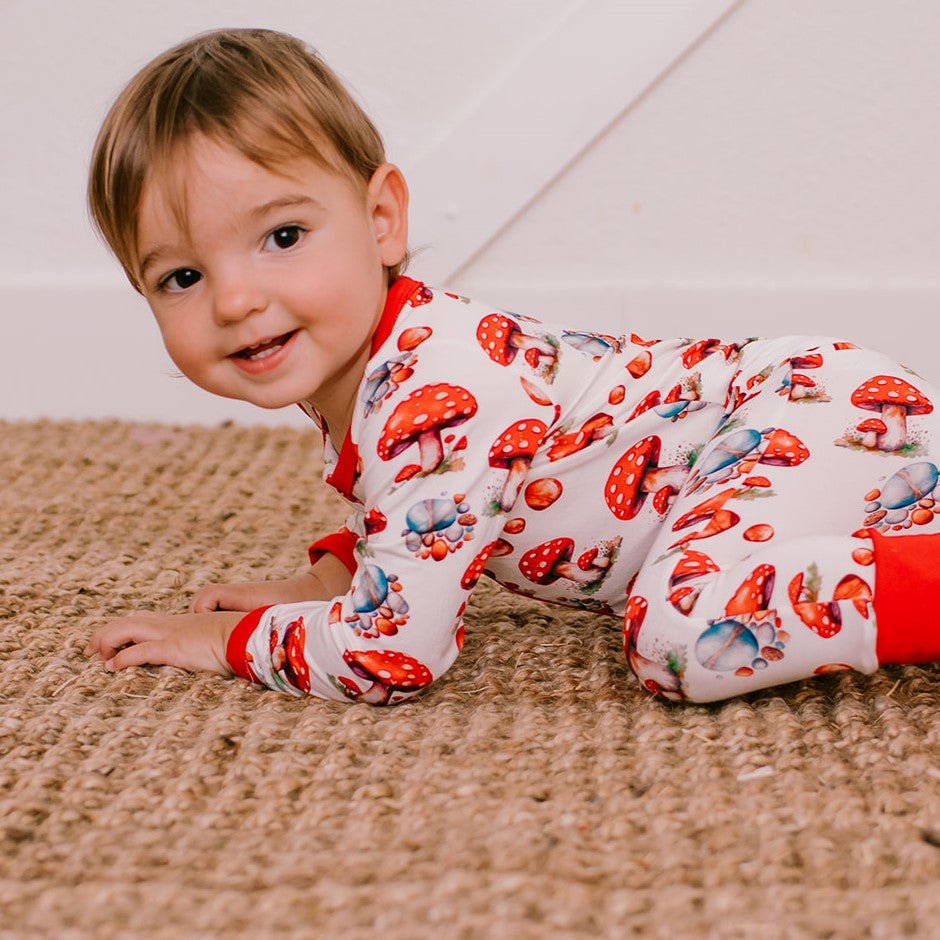 Baby coverall in a green frog-themed print with cuffed ankles and a front two-way zipper