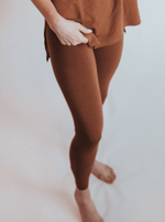 Women's leggings in a solid toffee brown shade shown full length.