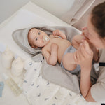 Mushie organic cotton muslin swaddle blanket, soft and breathable.