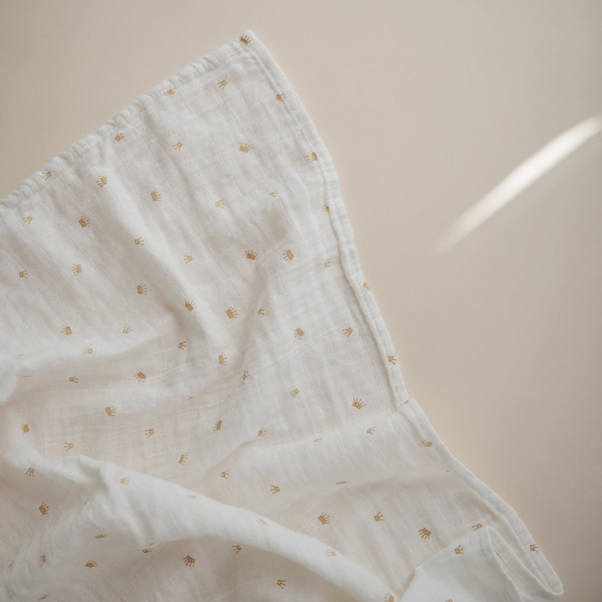 Mushie organic cotton muslin swaddle blanket, soft & breathable.