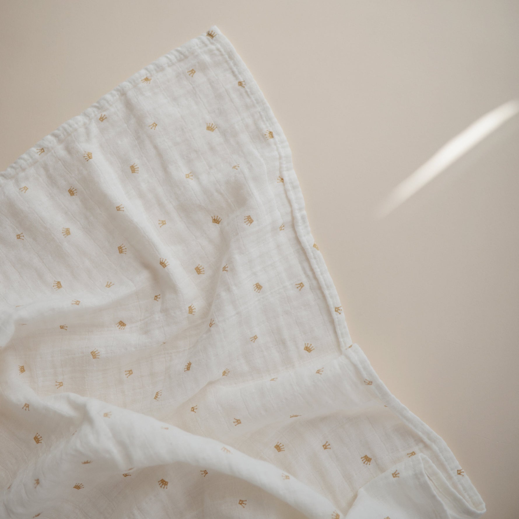 Mushie organic cotton muslin swaddle blanket, soft & breathable.