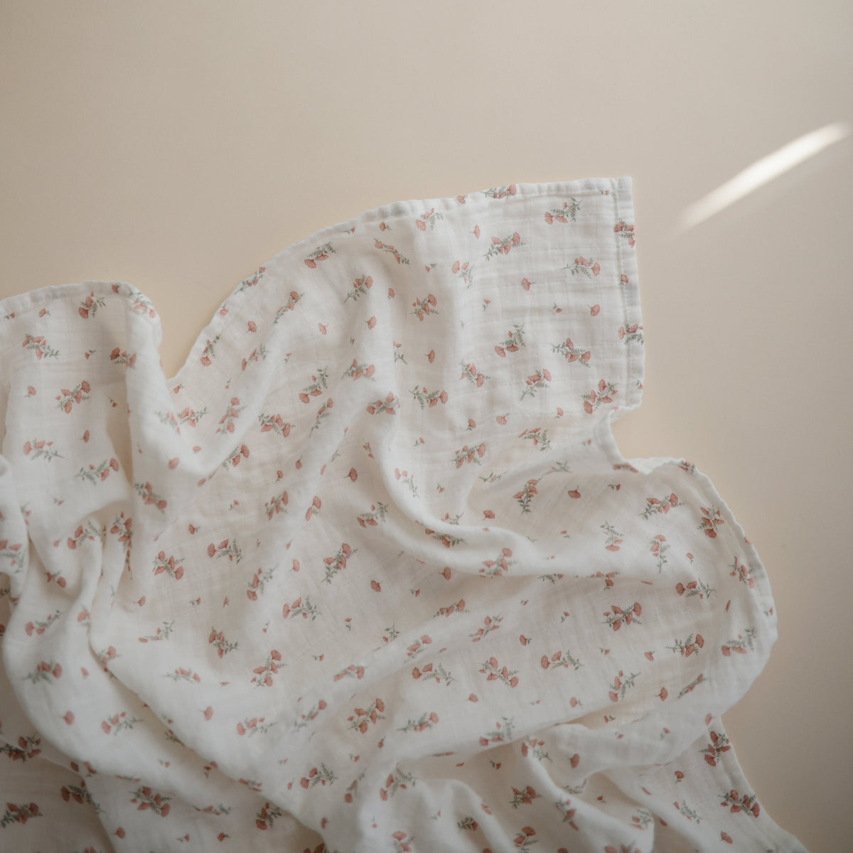 Mushie organic cotton muslin baby swaddle, soft & breathable.