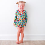 Bodysuit dress with a tropical fruit print, long sleeves, and snap closure at the inseam.