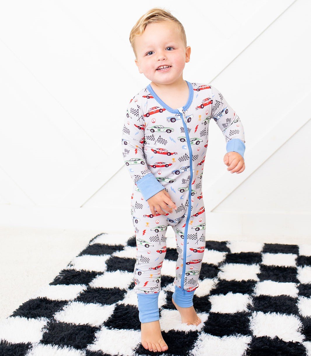 Baby coverall with a whimsical turbo cars print and a full-length front zipper for easy dressing