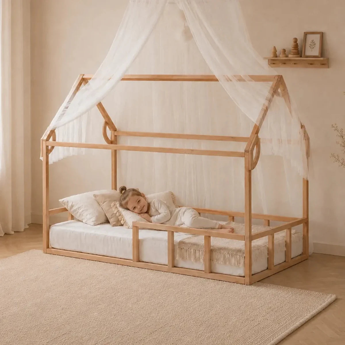 Montessori house bed for kids with a peaked roof frame and protective fence, low to the floor with slats