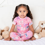 Short sleeve baby pajamas in a bow print, top and bottoms made from soft bamboo fabric