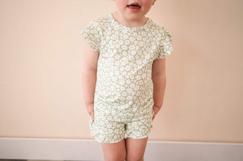 Two-piece short set in sage ditsy floral print with ruffle details.