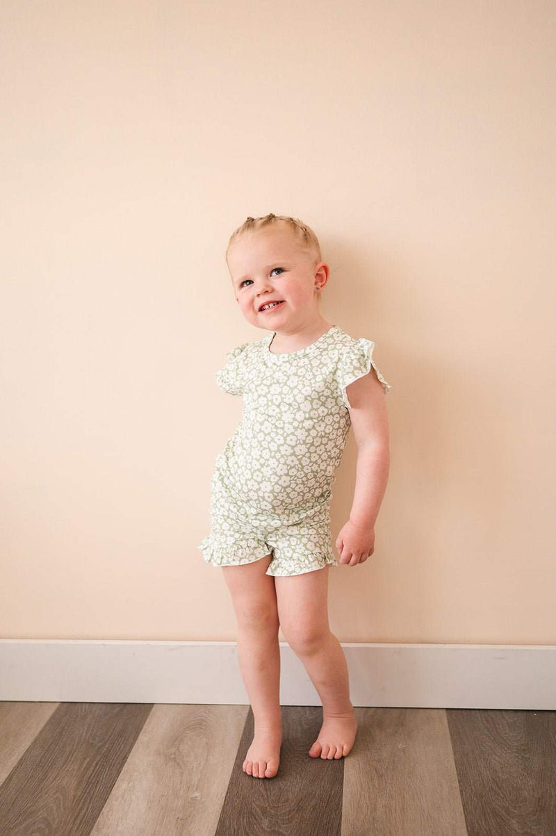 Toddler wearing a sage ditsy floral two-piece short set with ruffle details.