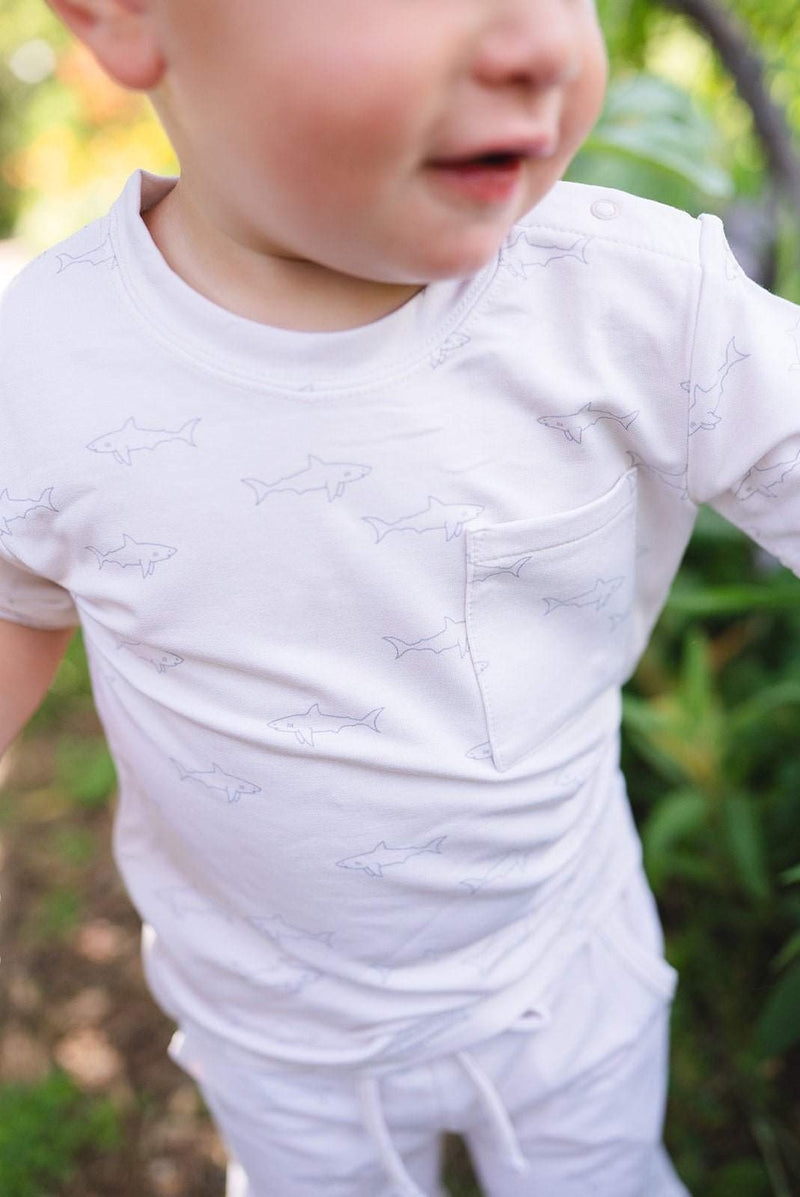 Cream and blue shark two-piece short set with pocket shirt and drawstring shorts for kids.