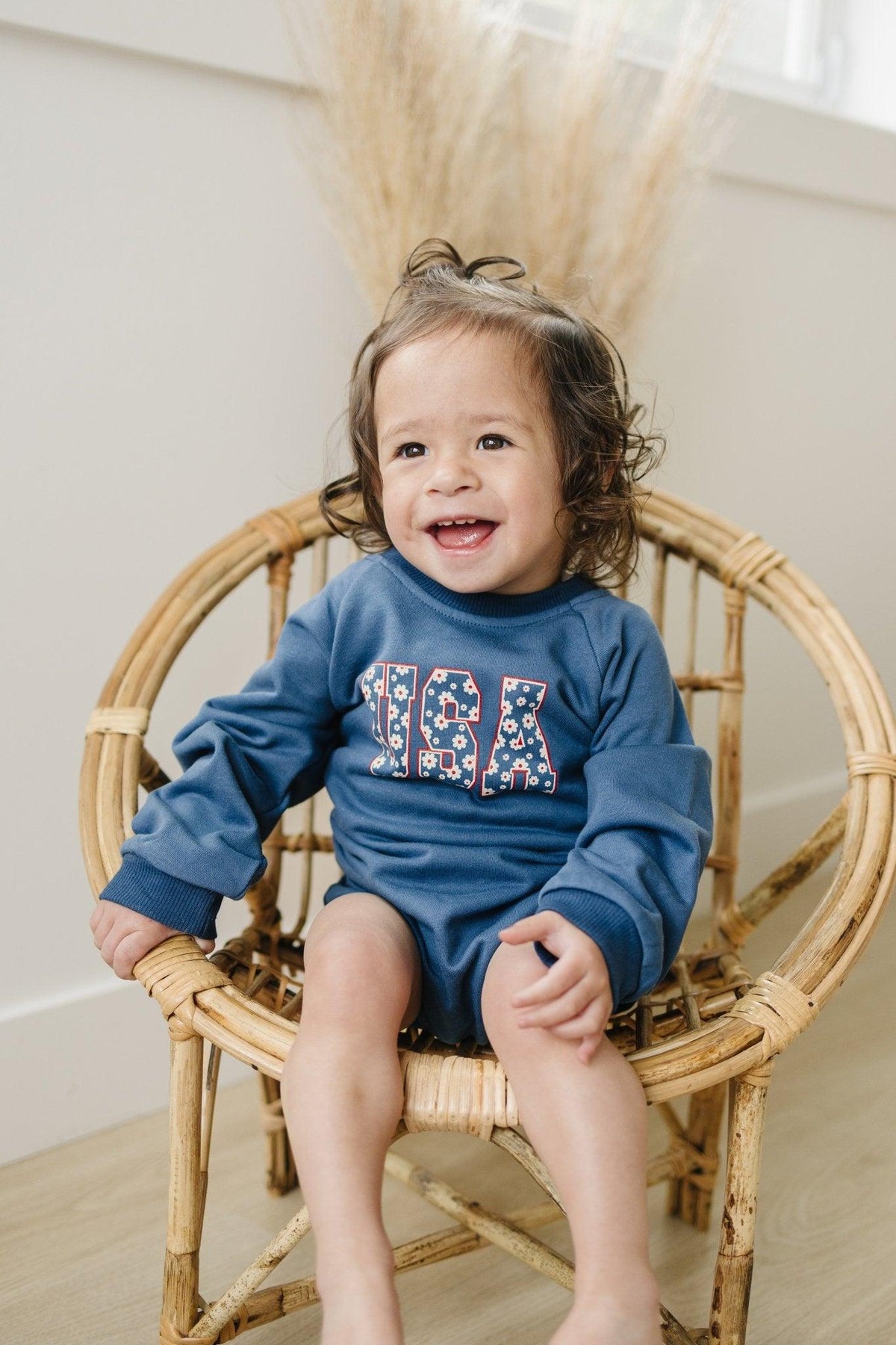 Little Joy Co. baby wearing a cozy, ultra-soft terry sweatshirt romper in a neutral color