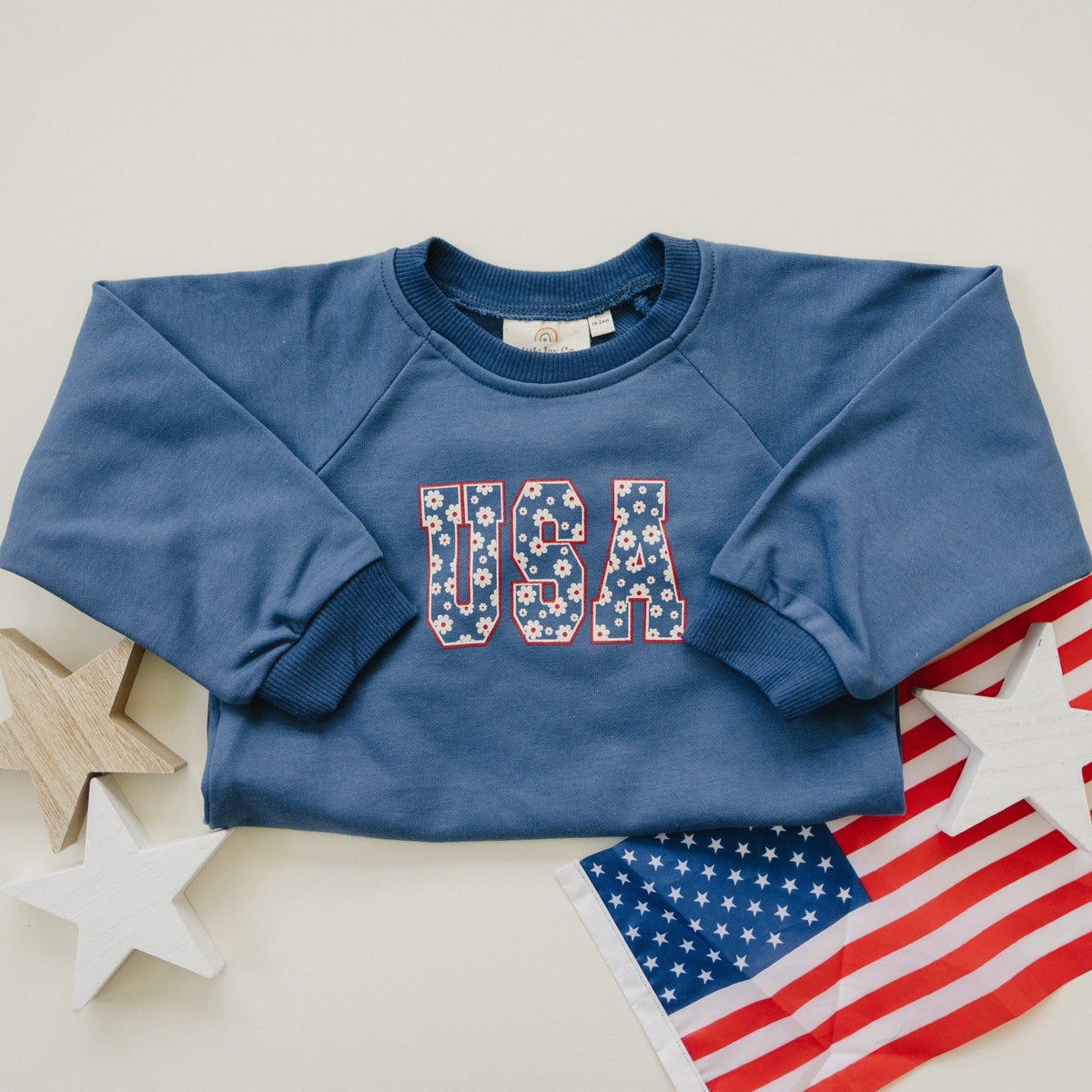 Little Joy Co. baby wearing a cozy, ultra-soft terry sweatshirt romper in a neutral color