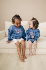 Little Joy Co. baby wearing a cozy, ultra-soft terry sweatshirt romper in a neutral color