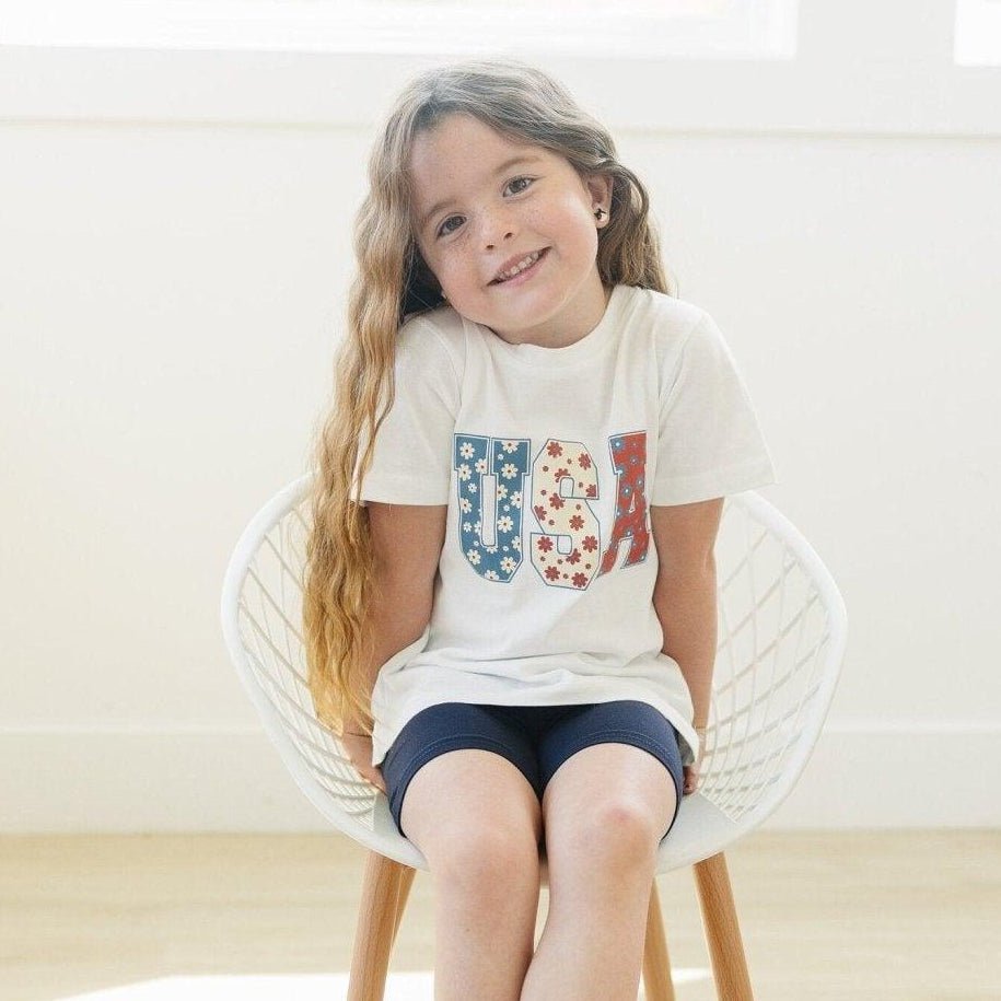 Little Joy Co. 100% organic cotton baby t-shirt in a neutral color, perfect for playtime.