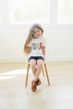 Little Joy Co. 100% organic cotton baby t-shirt in a neutral color, perfect for playtime.