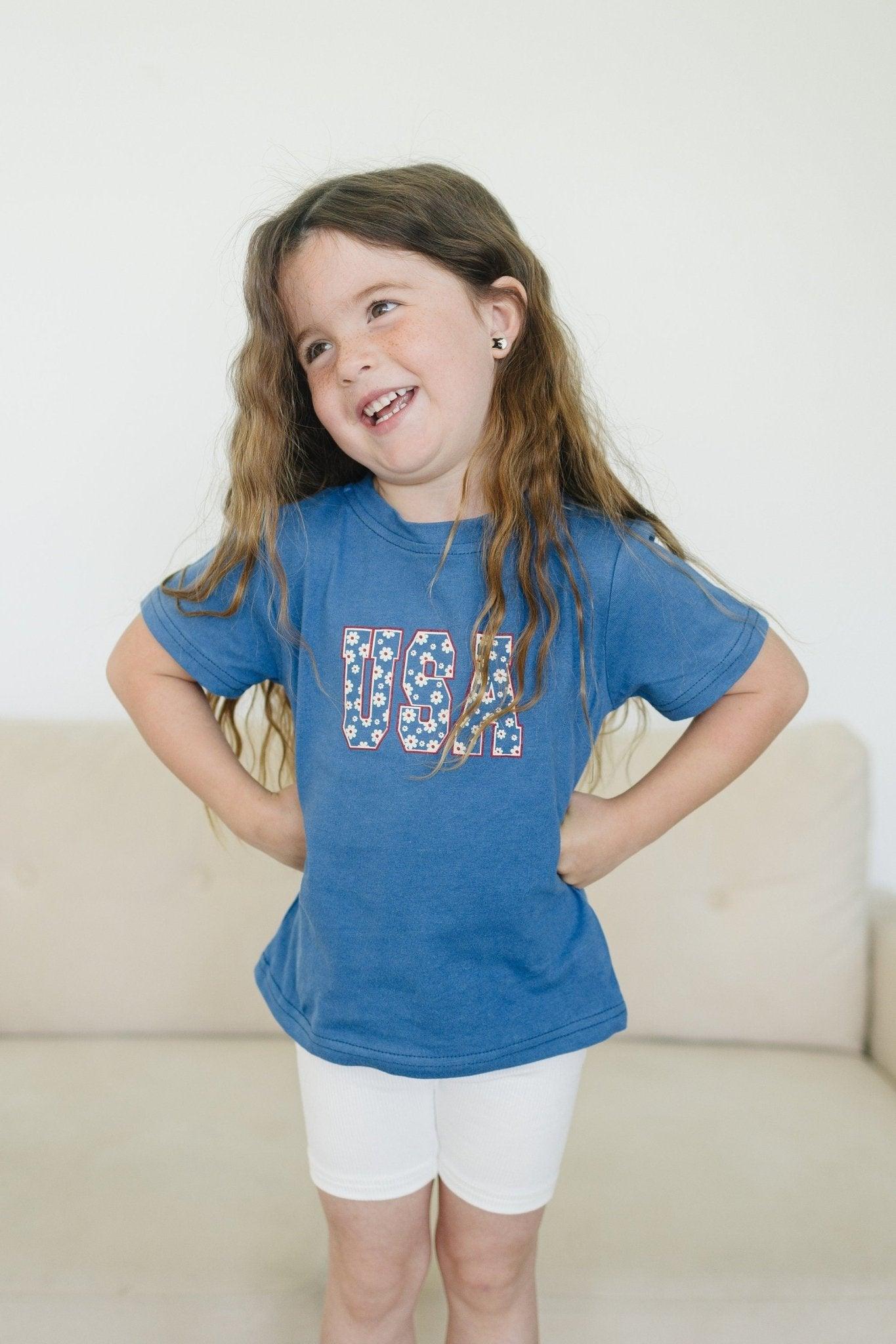 Little Joy Co. 100% cotton baby t-shirt in a soft, natural color, folded neatly.