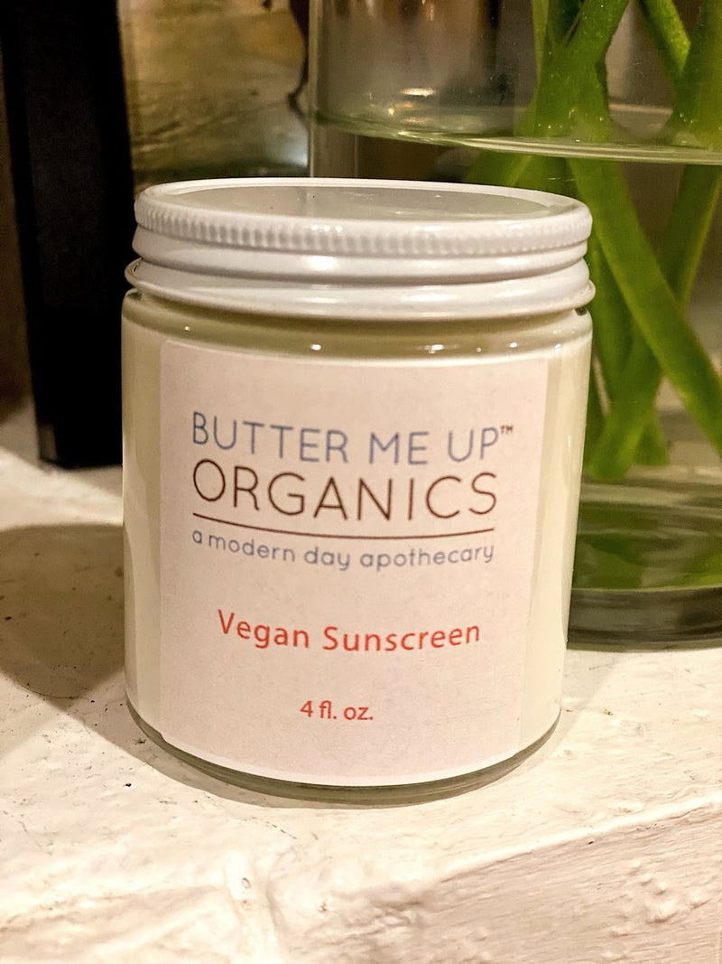 Vegan Organic Sunscreen SPF 45 in glass jar with metal lid on a shelf.