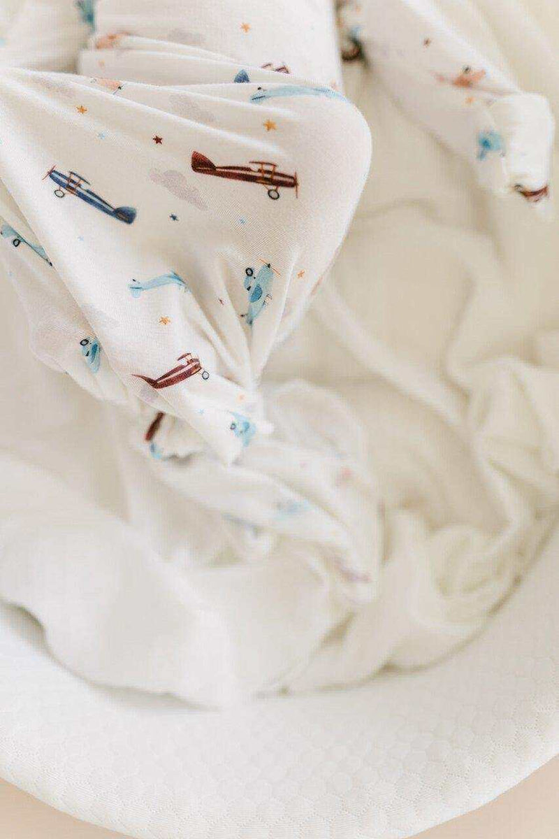 Knotted baby gown with vintage airplane print on bamboo viscose material.
