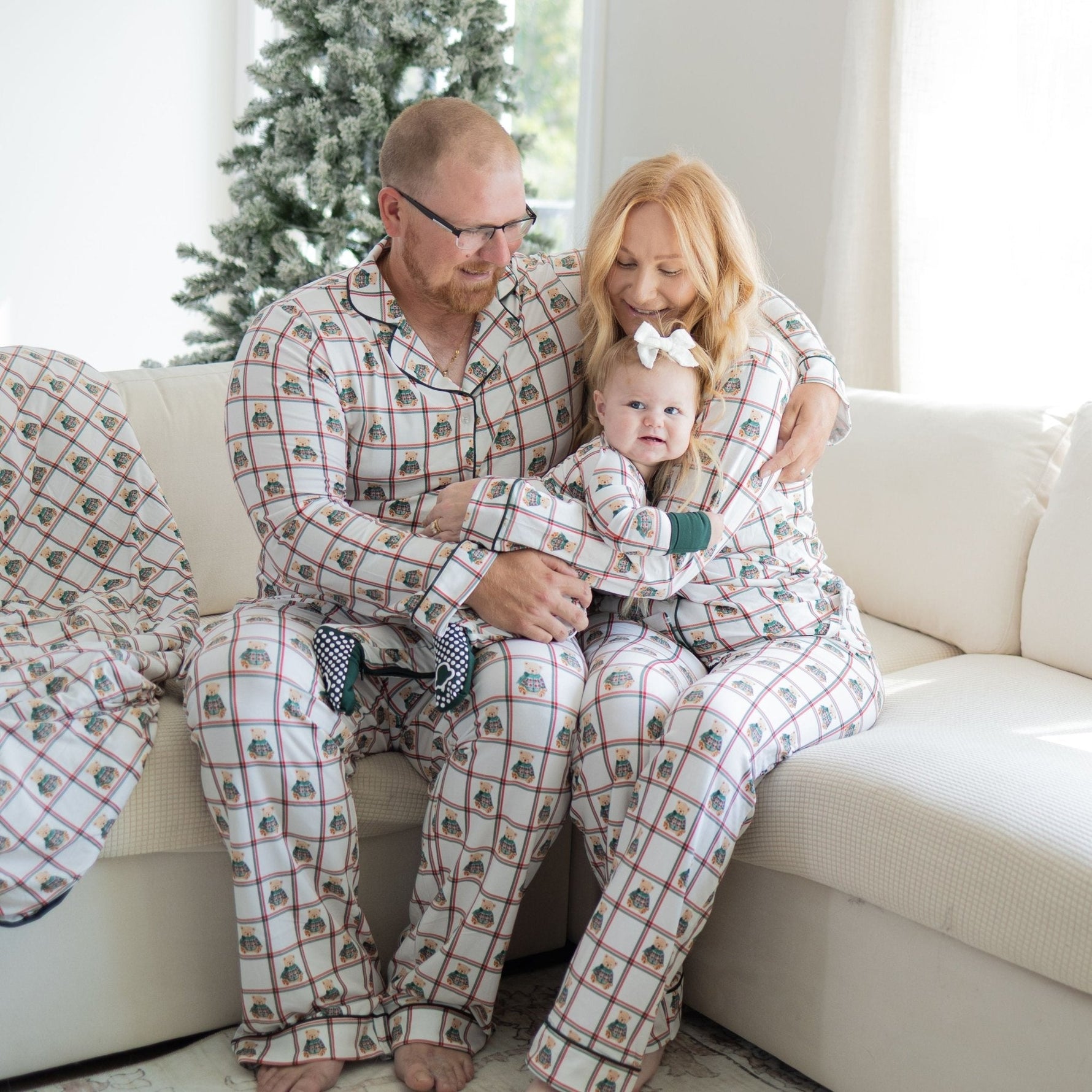 Unisex adult button-down pajama set with plaid pattern and teddy bears in green sweaters, paired with drawstring pants.