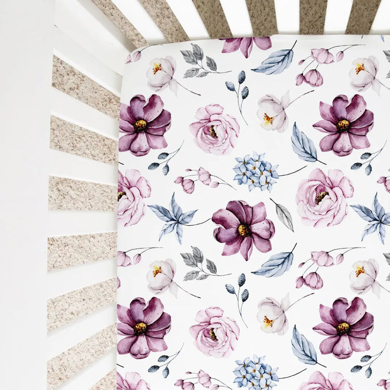 Fitted crib sheet with vintage floral pattern on a standard size crib.
