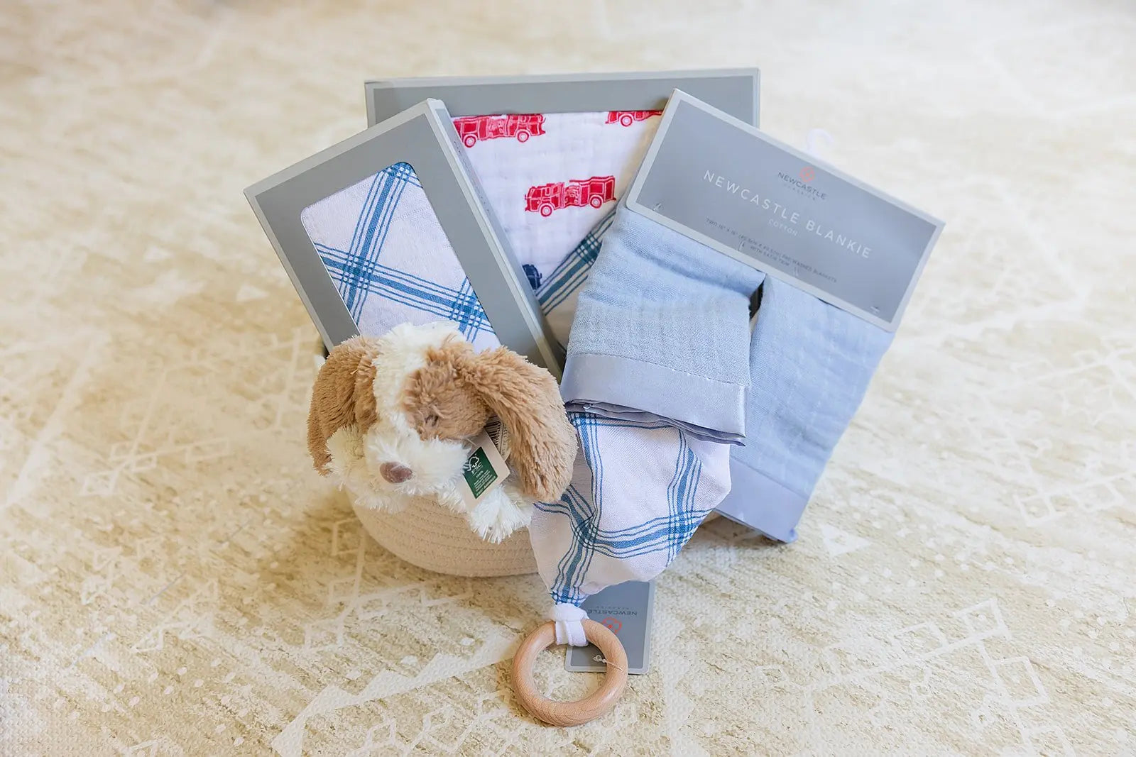 Welcome Baby Boy Firetruck and Blue Plaid Basket with Cotton Blanket Swaddle Blankie Set and Plush Dog Toy Newcastle Classics