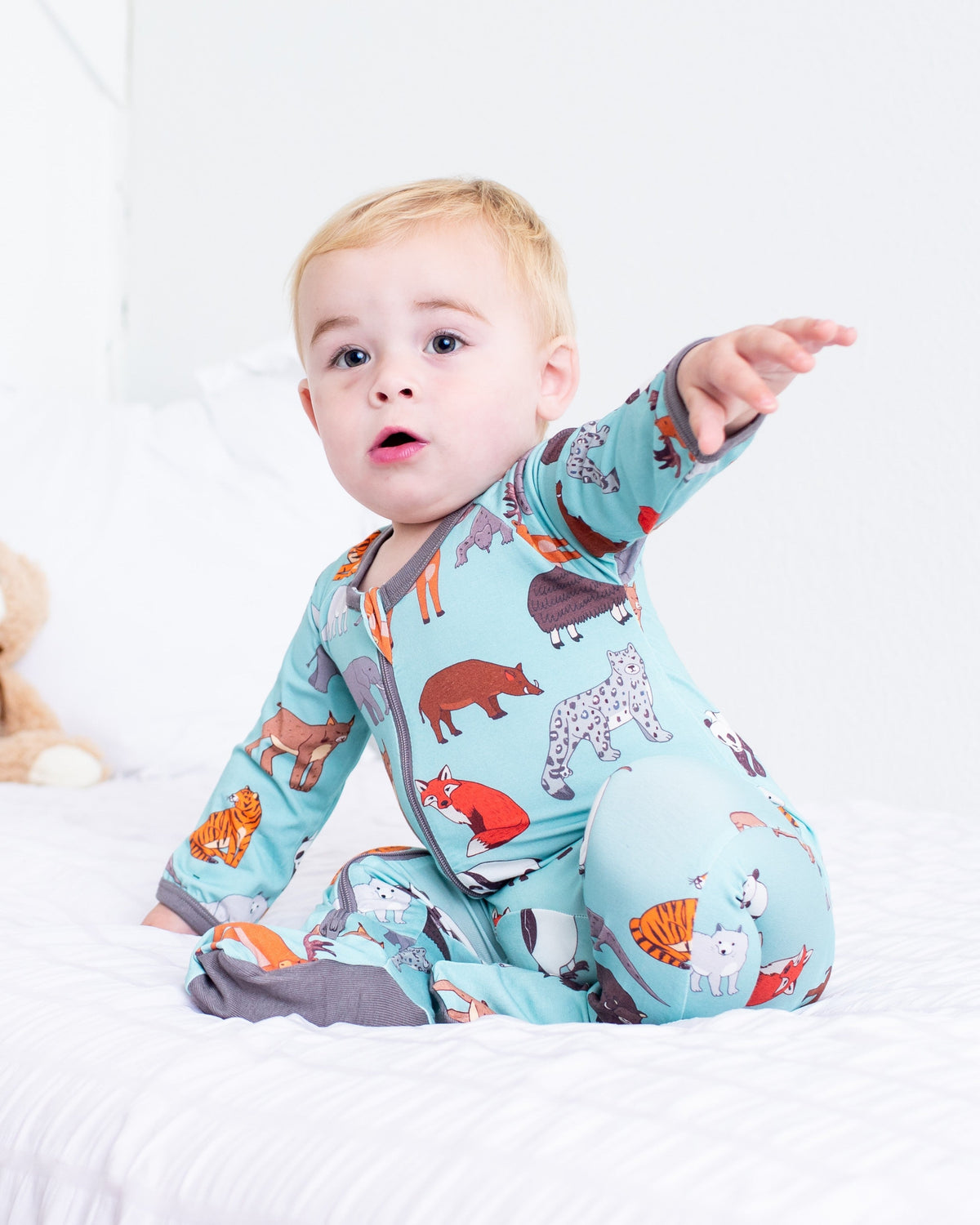 Baby footie pajamas in Wild Things animal print with full-length two-way zipper and covered feet
