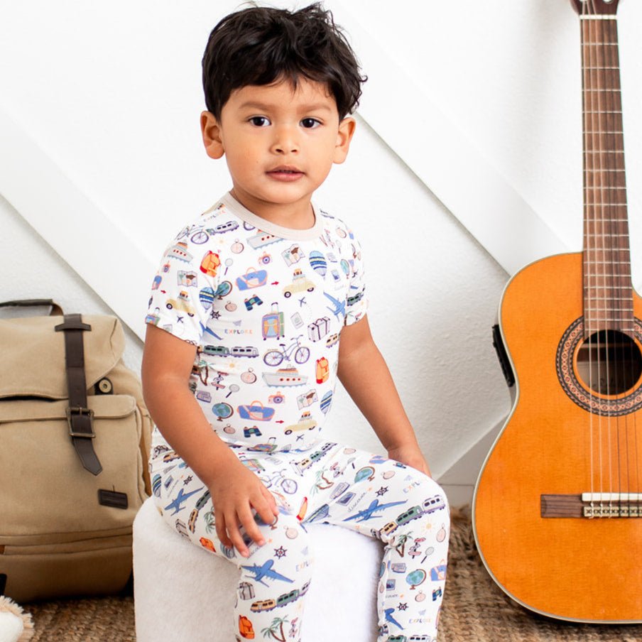 World Traveler short sleeve pajama set with travel-themed print, top and matching pants shown on a toddler