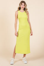 Model wearing a yellow ribbed maternity tank dress with a side slit, perfect for comfort and style.