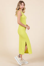 Child wearing a cheerful yellow ribbed side slit tank dress made from organic cotton, perfect for play.